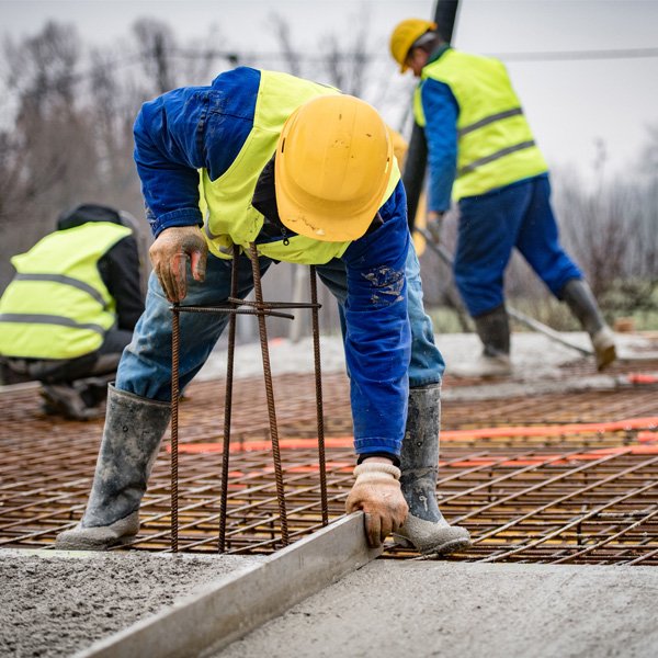 Workers levelling ground on construction site