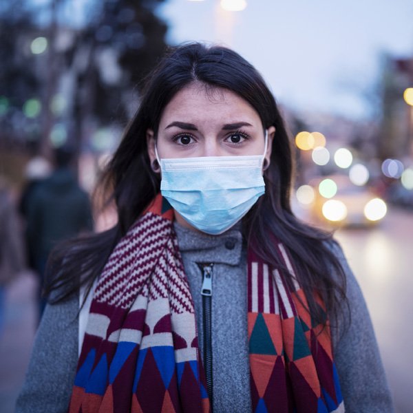 Young women wearing a face covering