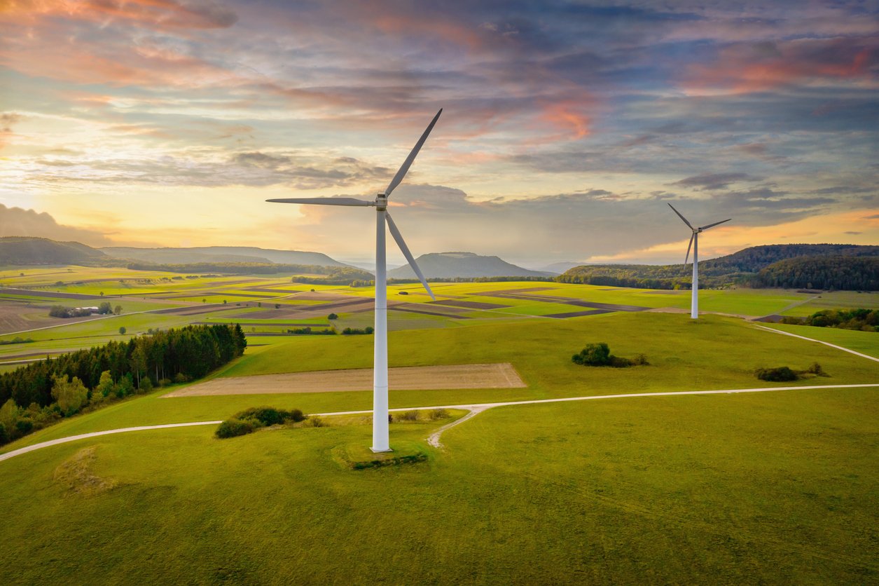 Alternative Energy Wind Turbine Green Landscape at Sunset