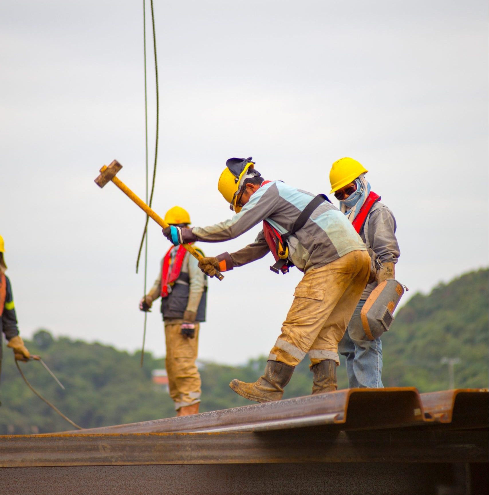 Workmen in hardhats working on scaffolding