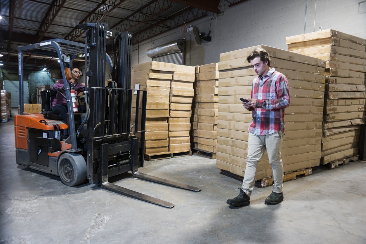 Forklift clashing with worker on phone