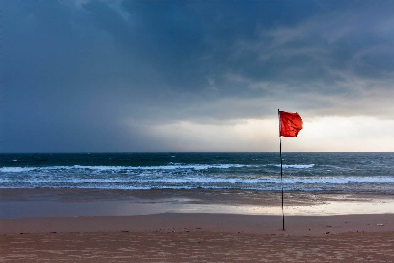 Storm warning flags on beach