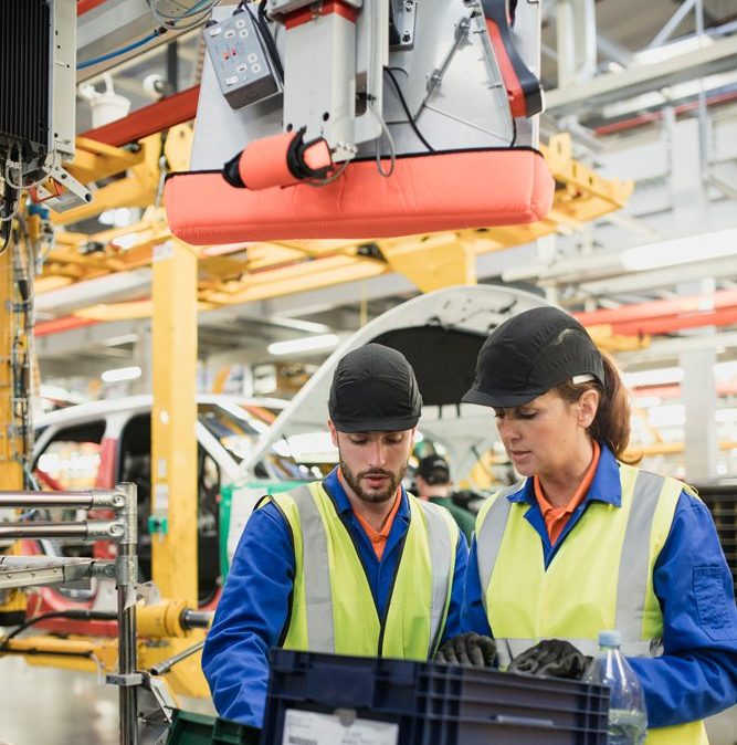 Trainee production line factory worker with his superior