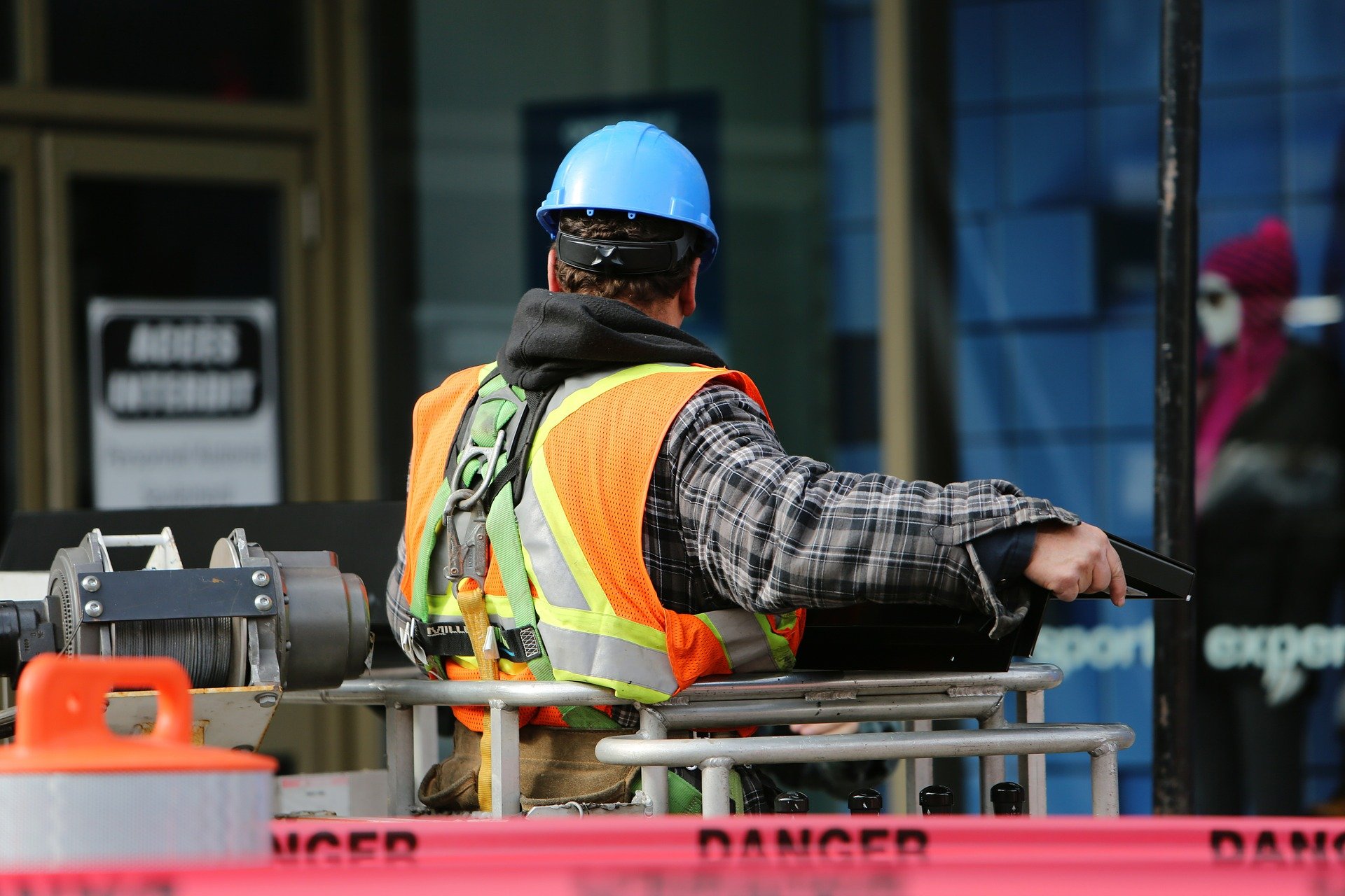 Site supervisor sitting on machinery