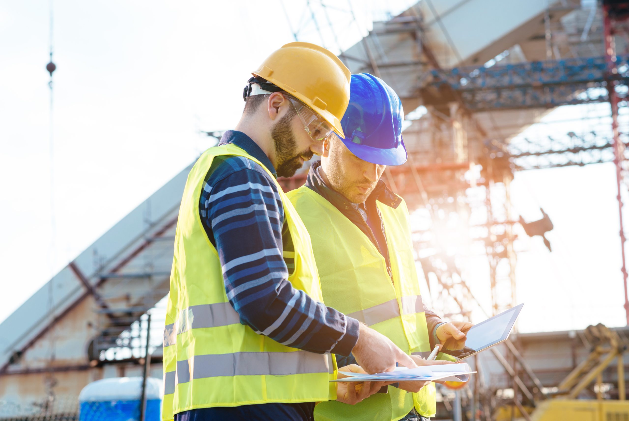 Main engineer showing report to contractor at construction site
